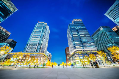 Low angle view of illuminated buildings against clear sky