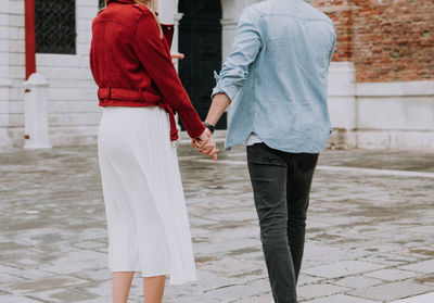 Rear view of couple standing outdoors