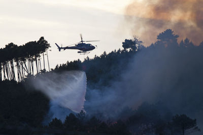 Helicopter flying over forest fire