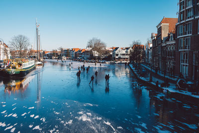 Boats in canal along buildings