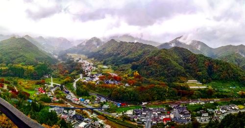 High angle view of townscape and mountains against sky