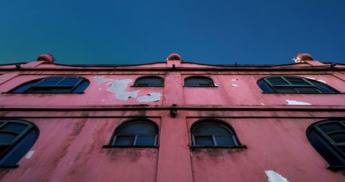 Low angle view of building against clear blue sky