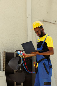 Rear view of man working at construction site