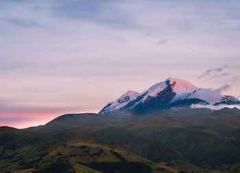 Scenic view of snowcapped mountains against sky during sunset