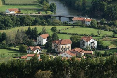 Scenic view of agricultural field by houses