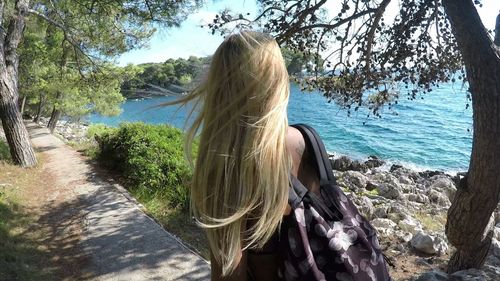 Rear view of woman looking at waterfall