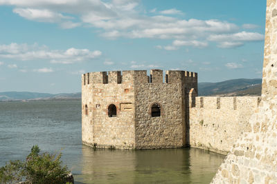 Historic building by sea against sky