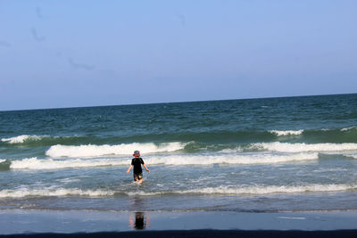 Man on beach against sky