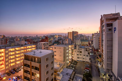 High angle view of illuminated buildings against sky during sunset