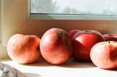 Close-up of apples on window sill at home