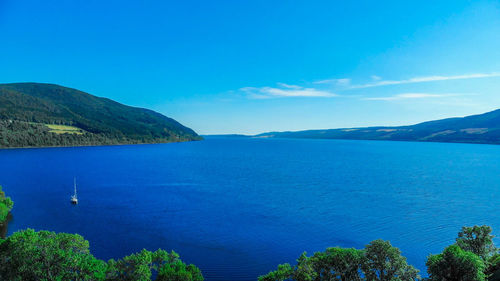 Scenic view of sea against blue sky