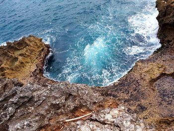 High angle view of rocks in sea