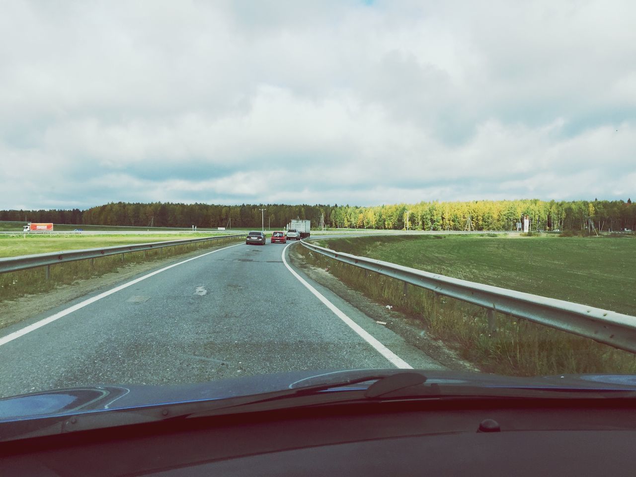 transportation, mode of transport, road, sky, cloud - sky, land vehicle, car, vehicle interior, glass - material, road marking, on the move, cloudy, windshield, transparent, cloud, travel, landscape, the way forward, weather, country road