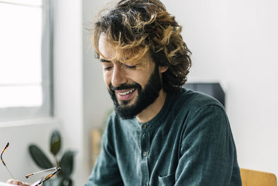 Happy freelancer with eyeglasses at coworking office