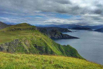 Scenic view of mountains against cloudy sky