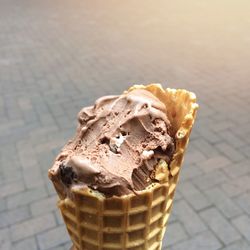 Close-up of ice cream cone on footpath