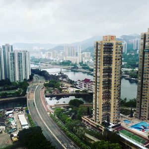 High angle view of street amidst buildings in city against sky