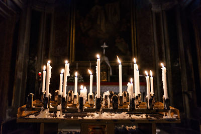 Close-up of illuminated candles at church