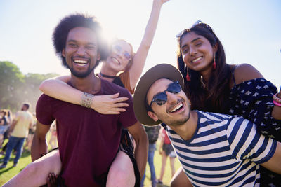 Portrait of smiling friends against sky