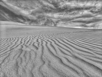 Sand dune in desert against sky