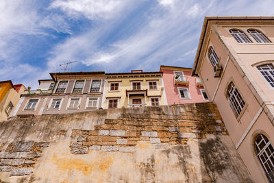 View from below of the houses of the city walls of the old university city of coimbra, portugal