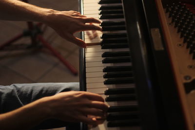 Close-up of man playing piano