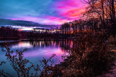 Scenic view of lake against sky at sunset