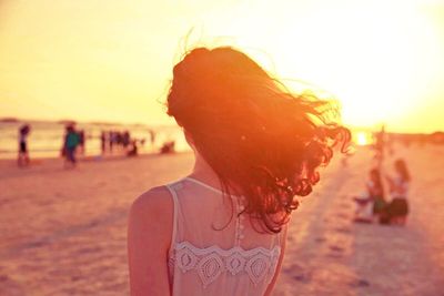 Rear view of woman standing on beach