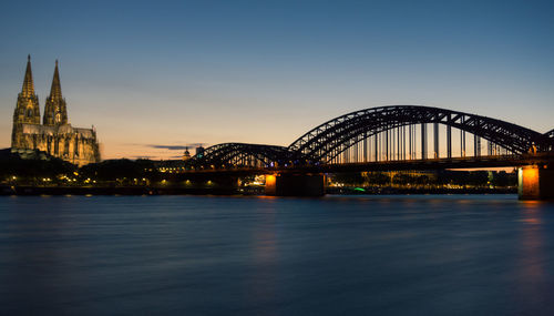 View of bridge over river at sunset