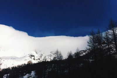 Scenic view of snow covered mountains against sky