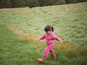 Side view of girl on grassy field