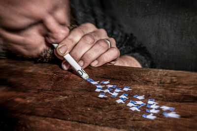 Midsection of man holding text on table