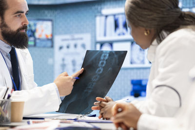 Side view of doctor examining patient in office