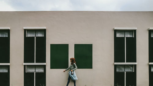 Man standing against window