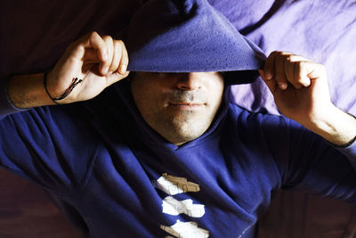 Close-up of man wearing hooded shirt