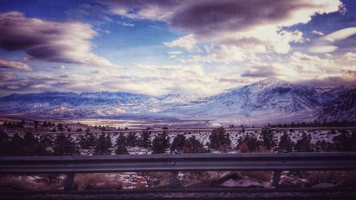 Scenic view of mountains against cloudy sky