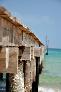 Wooden pier on sea against sky