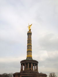 Low angle view of statue against cloudy sky