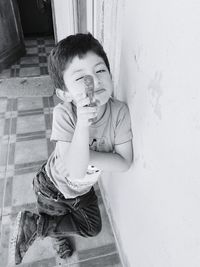 Portrait of little boy aiming with toy gun