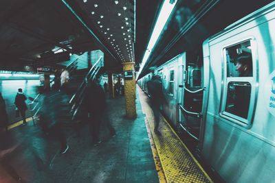 Defocused image of train at railroad station during night