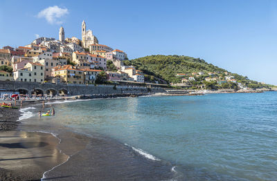 The beach of cervo with his beautiful historic center in background