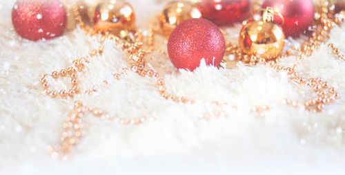 Close-up of christmas ornaments on fur