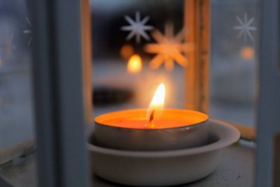 Close-up of illuminated tea light candle