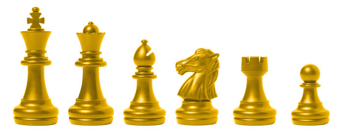 Close-up of chess pieces against white background