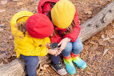 High angle view of children playing with yellow land