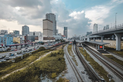 High angle view of railroad tracks in city against sky