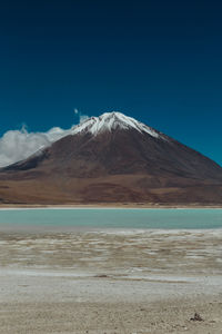 Scenic view of mountains against blue sky