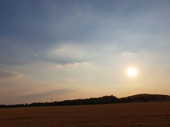 Scenic view of field against sky during sunset