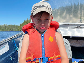 Portrait of boy looking at boat