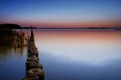 Scenic view of lake against sky during sunset